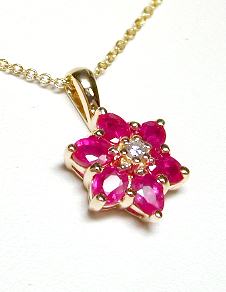 
Oval Ruby and Diamond Flower Pendant
